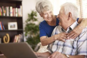 senior marriage using laptop living room min